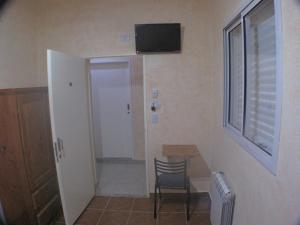 a room with a table and a chair and a window at Hotel Los Cedros in Buenos Aires