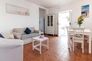 a living room with a couch and a table at Living Sperlonga in Sperlonga