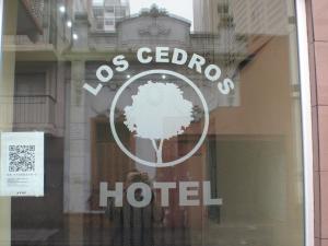 a sign in the window of a hotel at Hotel Los Cedros in Buenos Aires