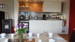 a kitchen with a table with flowers on it at Appartment Bürger-Hinteregger in Seeboden