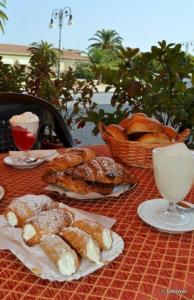 a table topped with pastries and a basket of bread at Thea B&B in Acquedolci