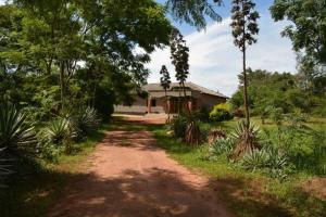 a dirt road in front of a house at Serviced apartment (3 bedrooms) in Lusaka