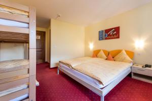 Postel nebo postele na pokoji v ubytování Hotel Alex