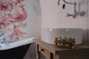 a bathroom with a sink and a tub and a table at Monastery Garden Bistro & Rooms in Český Krumlov +78 photos