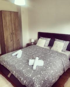 a bedroom with a bed with two towels on it at Apartman KEJ in Pirot +32 photos
