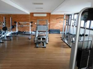 a gym with several treadmills and machines at Crystal Place 2 in Goiânia