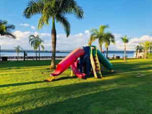 a slide in a park next to the beach at Flat Romântico à Beira Lago M 401 in Brasilia