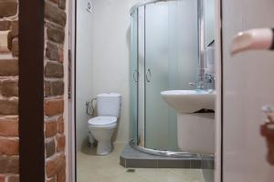 a bathroom with a shower and a toilet and a sink at Hotel Slivnitsa in Burgas +10 photos