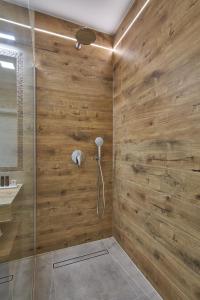 a bathroom with a shower with wooden walls at Apartament Premium Aquatower Reda in Reda