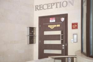 a brown door with a registration sign on a wall at Hotel Slivnitsa in Burgas