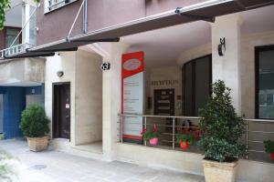 a facade of a restaurant with potted plants in the window at Hotel Slivnitsa in Burgas