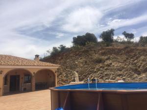 dom z basenem przed wzgórzem w obiekcie Casa Cuatro Vientos - Barranco Del Sol w mieście Almogía