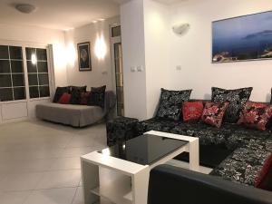 a living room with a couch and a table at Apartments Stefan in Sveti Stefan