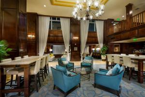 a dining room with tables and chairs and a chandelier at The Shores Resort & Spa in Daytona Beach