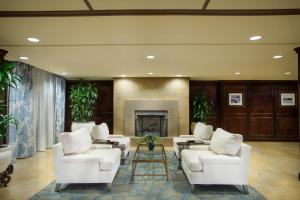 a lobby with white chairs and a fireplace at The Shores Resort & Spa in Daytona Beach