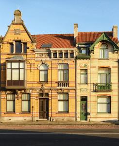a large brick building with a red roof at B&B Villa Chantecler in Bruges