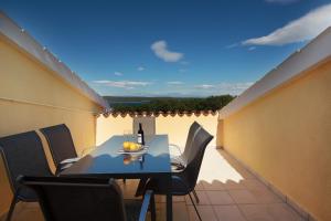 a balcony with a table and chairs on a roof at Apartments Galboka in Nerezine