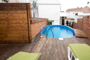 a swimming pool on top of a wooden deck at Elena Rooms in Split
