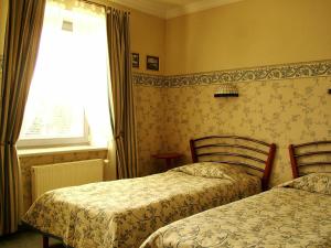 Postel nebo postele na pokoji v ubytování Hotel Marmułowski