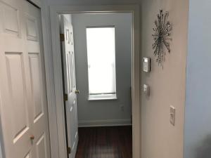 an empty hallway with a window and a door at Peaceful Getaway for Two in Lincolnville/Quiet Area/2.3 Miles to Beach in St. Augustine