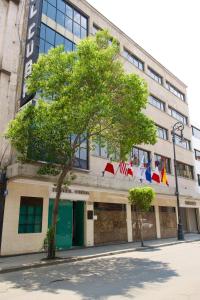 a building with flags on the front of it at Hotel Cuba in Mexico City