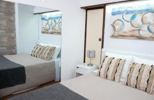 
a hotel room with a bed and a painting on the wall at Casa da Sereia in Sesimbra
