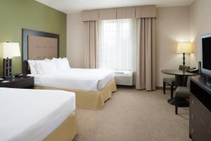 a hotel room with two beds and a television at Holiday Inn Express Hotel & Suites North Sequim, an IHG Hotel in Sequim