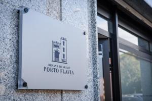 a sign on the side of a building at Bed and Breakfast Porto Flavia in Iglesias