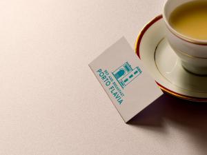a cup of coffee and a card that says happy birthday at Bed and Breakfast Porto Flavia in Iglesias