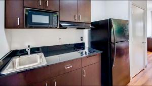 a kitchen with a sink and a microwave and a refrigerator at Motel 6-San Angelo, TX in San Angelo