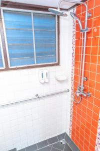 a bathroom with a shower with a window at Lai Thai Guest House in Chiang Mai