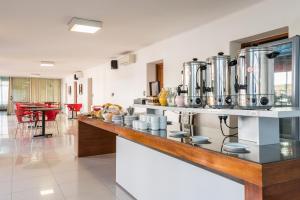 a kitchen with a counter with many pots and pans at Hotel Ritz in Alta Gracia