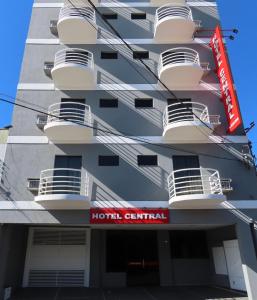 a hotel central building with balconies and a hotel central sign at Hotel Central in Lins