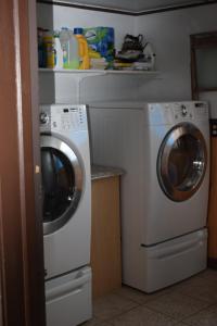 a washing machine and a washer in a kitchen at Bird Island B&B in Elliston