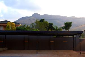 a black garage with a mountain in the background at Green Haven Apartments in Ezulwini
