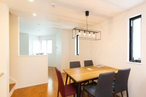 a dining room with a table and chairs at Sangen-jaya House-O in Tokyo