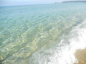 a large body of water with a sandy beach at Hotel Corsaro Nero in Portu Maga