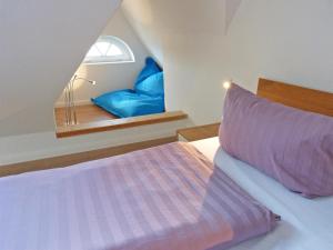 a bedroom with a bed with a window and a pillow at Haus Nordlicht Ferienwohnung *Bi a Maln* in Nebel
