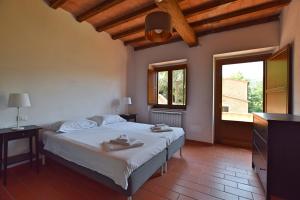 Ένα ή περισσότερα κρεβάτια σε δωμάτιο στο Borgo Gatteraia
