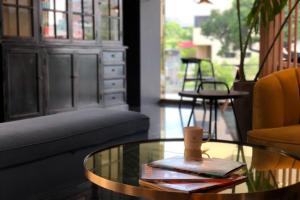 a living room with a glass table and a couch at Talmud Hotel Taichung in Taichung