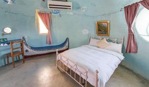 Giường trong phòng chung tại Kenting Ha-Bi Star Fort