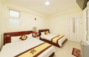 Postel nebo postele na pokoji v ubytování An Phu Hotel Da Lat
