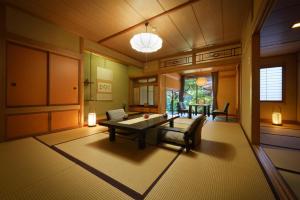 a living room with a table and chairs in it at Shouhakutei Azumaso in Tendo