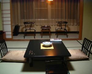 a black table with chairs and a bowl on it at Shouhakutei Azumaso in Tendo +59 photos
