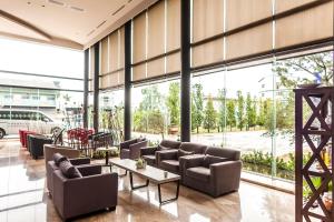 a lobby with couches and tables and large windows at Look Royal Resort in Chiayi City