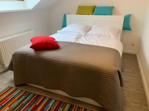 a bedroom with a large bed with two pillows on it at Apartments Rischmühle in Emmerthal