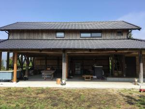 a large wooden building with a picnic table in it at SOCKET in Minami Aso
