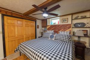 a bedroom with a bed and a ceiling fan at Guest Suite at The Red House basement attached with private entrance in Salt Lake City