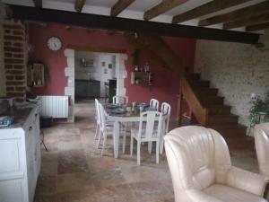 a kitchen and dining room with a table and chairs at Chambre d'hôte Monthodon in Monthodon