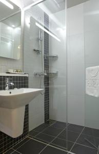 een badkamer met een wastafel en een glazen douche bij Ocloud Hotel Gangnam in Seoul